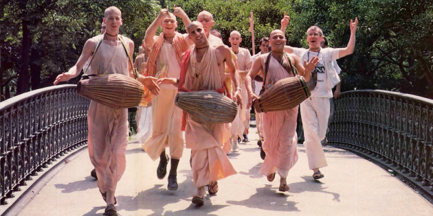 Hare Krishna Brahmacaris Chanting Crossing a Bridge in a Park